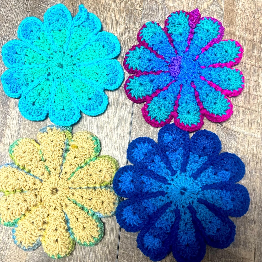 Knitted retro flower hotplate/potholders. Set of four in primary colors.